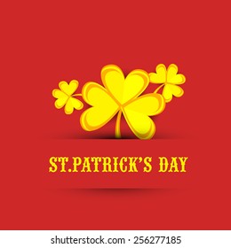 St. Patrick's Day celebration concept with golden shamrock leaves on red background.