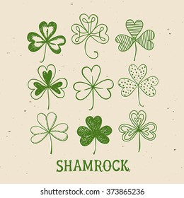 St. Patrick's day doodle shamrocks set. Hand drawn three leaf clover on old paper background for your design.