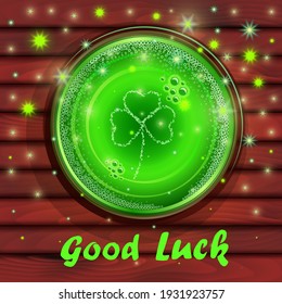 St. Patrick's Day. Good luck! Glass of beer. Irish holiday on March 17th. Glass of green beer on a wooden table, top view. Magic sparks.