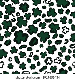 St. Patrick's Day Leopard or jaguar seamless pattern made of shamrock or clover leaves. Spotted cheetah fur. Trendy animal print. Vector background for fabric, textile, wallpaper, wrapping paper, etc.