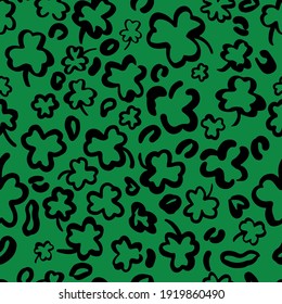 St. Patricks Day Leopard or jaguar seamless pattern made of shamrock or clover leaves. Trendy animal print. Spotted cheetah skin. Vector background for fabric, textile, wallpaper, wrapping paper, etc.