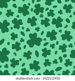 St. Patricks Day Leopard or jaguar seamless pattern made of shamrock or clover leaves. Spotted cheetah skin. Trendy animal print. Vector background for textile, fabric, wallpaper, wrapping paper, etc.