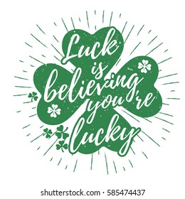 St. Patrick's Day quote typography lettering greeting card template on a grunge texture green shape with lucky shamrock clover for print, t-shirt, design element. Luck is believing you're lucky