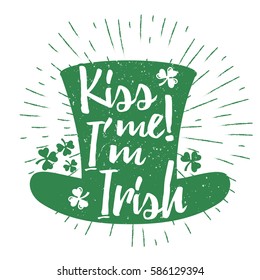 St. Patrick's Day quote typography lettering greeting card template on a grunge texture green leprechaun's hat with lucky shamrock clover for print, t-shirt, design element. Kiss me I'm Irish