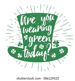 St. Patrick's Day quote typography lettering greeting card template on a grunge texture green leprechaun's hat with lucky shamrock clover for print, t-shirt, design element. Are you wearing green