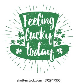 St. Patrick's Day quote typography lettering greeting card template on a grunge texture green leprechaun's hat with lucky shamrock clover for print, t-shirt, design element. Feeling lucky today