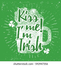 St. Patrick's Day quote typography lettering greeting card template on a grunge texture green shape with lucky shamrock clover for print, t-shirt, decorative festive design element. Kiss me I'm Irish