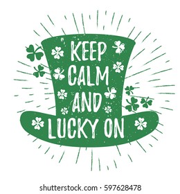 St. Patrick's Day quote typography lettering greeting card template on a grunge texture green leprechaun's hat with lucky shamrock clover for print, t-shirt, design element. Keep calm and lucky on
