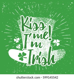 St. Patrick's Day quote typography lettering greeting card template on a grunge texture green shape with lucky shamrock clover for print, t-shirt, decorative festive design element. Kiss me I'm Irish