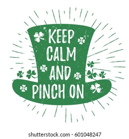 St. Patrick's Day quote typography lettering greeting card template on a grunge texture green leprechaun's hat with lucky shamrock clover for print, t-shirt, design element. Keep calm and pinch on