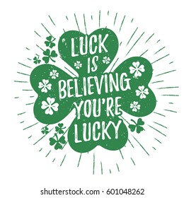 St. Patrick's Day quote typography lettering greeting card template on a grunge texture green shape with lucky shamrock clover for print, t-shirt, design element. Luck is believing you're lucky