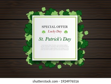 St. Patrick's Day sale wording on  white banner, clovers and brown wooden board background. St. Patrick's Day greeting card in  vector design.