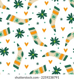 St. Patrick's Day seamless vector pattern. Festive socks, clover leaves and hearts for good luck. Irish holiday symbols. Quatrefoil, trefoil for fortune. Flat background for wallpapers, cards, prints