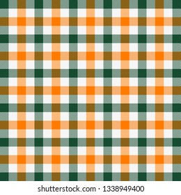 St. Patricks day tartan plaid. Scottish pattern in green, orange and white cage. Scottish cage. Traditional Scottish checkered background. Fabric texture. Vector illustration