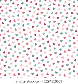 St. Valentine's Day seamless pattern with colorful hearts on white background. Perfect for gift paper, greeting cards, wallpaper. Hand drawn vector illustration. 