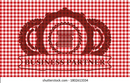 stack of books icon and Business Partner text red checkered tablecloth realistic emblem. Restaurant classic background. Artistic illustration. 