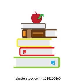 Stack of books on a white background. Apple laid on it.