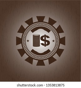 stack of coins icon inside retro wooden emblem
