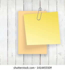 Stack of colored stickers attached metal paper clip with curled corner, ready for your message. Set of color stickers isolated on white wooden boards wall background. illustration set paper Front view