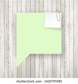 Stack of colored stickers attached metal paper clip with curled corner, ready for your message. Set of color stickers isolated on white wooden boards wall background. illustration set paper Front view