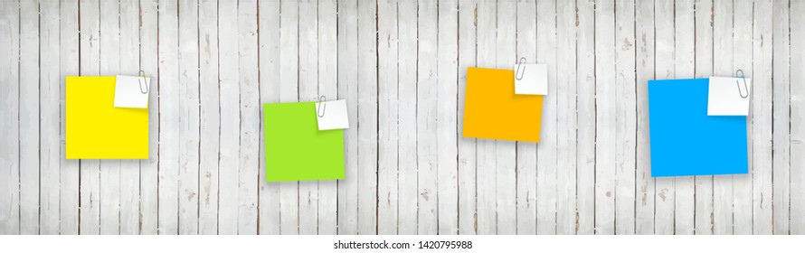 Stack of colored stickers attached metal paper clip with curled corner, ready for your message. Set of color stickers isolated on white wooden boards wall background. illustration set paper Front view