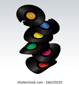 stack of curved and cracked vinyls