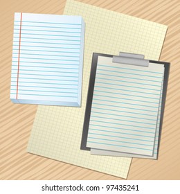 stack of paper and a clipboard on the table