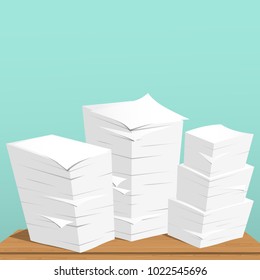 Stack of white sheets and paper in office on brown table top.