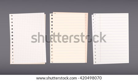 Stacked white, brown squared, ruled notebook paper are on dark background