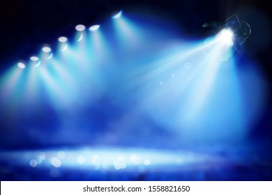 Stage during the show illuminated by spotlights. Blue background. Vector illustration.