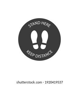 Stand here Keep Distance sign on black circle background. Vector icon.