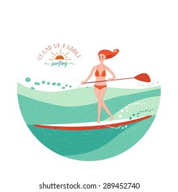 Stand Up Paddle Surfing. Young girl rides on the board making little steps. Green waves.