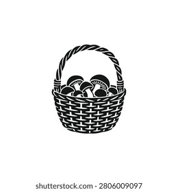 A standalone wicker foraging basket with a prominent arched handle in a rustic block stamp style