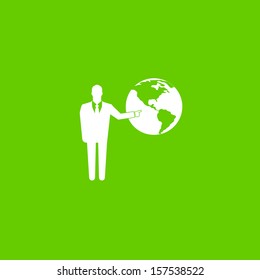 Standing businessman pointing  on the globe on green background