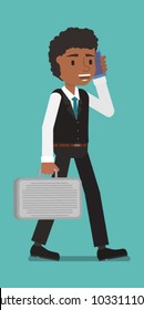 A standing manager speaks on the phone.