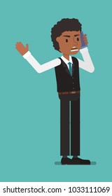 A standing manager speaks on the phone.