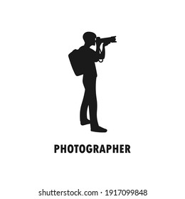Standing Photographer Black Silhouette. Man Holding A Digital DSLR Camera. Taking Picture Logo. Shooting Image. Journalist Or Paparazzi Job Icon Sign Or Symbol. Traveler Or Tourist Illustration.