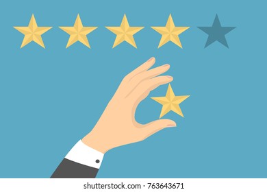 Star quality rating. Hand picking the star for review.