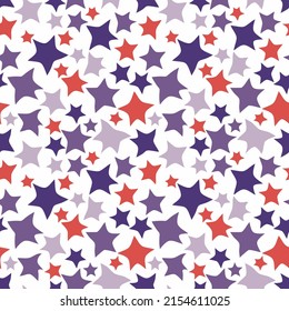 Starry colorful seamless pattern. Multi-colored stars of different sizes are randomly located on a white background. Hand drawing. Vector.