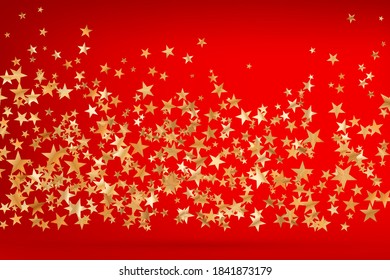 Stars golden glitter confetti isolated on blurred abstract red background. Festive holiday background. Celebration concept. Falling magic gold  particles. Invitation mock up. Top view, flat lay.
