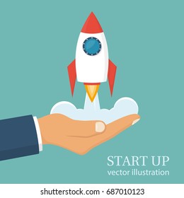 Start up concept. Businessman holds a flying rocket in hand, symbol of start of project's launch. Vector illustration cartoon flat design. Isolated on white background. Business metaphor.