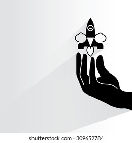 start up concept, hand holding rocket