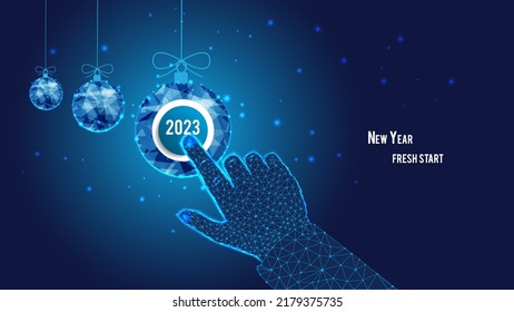 Startup concept. New Year fresh start. 2023 on the button. Polygonal hand. Clicking. Polygonal Christmas balls. Background of the blue starry sky.