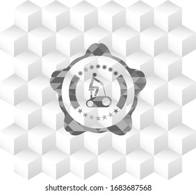 stationary bike icon inside grey emblem with cube white background