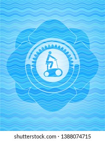 stationary bike icon inside water wave badge.
