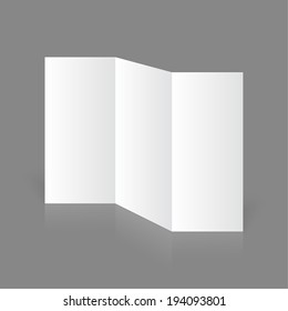 Stationary positioned blank three fold paper brochure on gray background. 