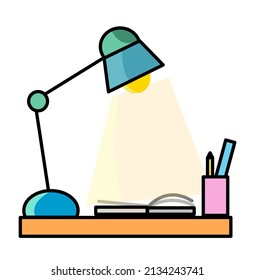 Stationary table with lamp and a book.