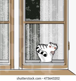 statuette of a cat on window sill