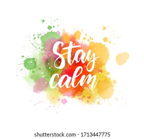 Stay calm  - handwritten modern calligraphy lettering on colorful watercolor paint splashes. Green and orange colored.