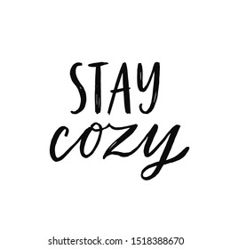 Stay cozy. Hand written lettering quote. Cozy phrase for winter or autumn time. Modern calligraphy poster. Inspirational fall sign. Black and white overlay.